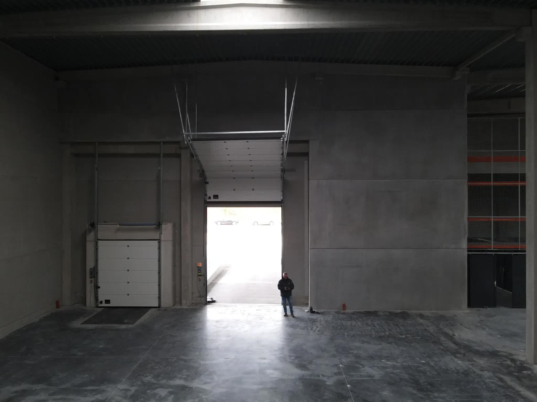 Warehouse loading dock with high sectional door